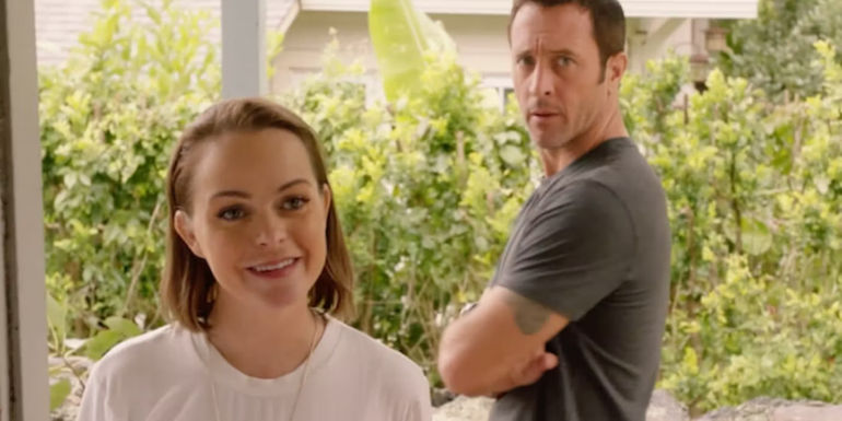 Mary smiling with Steve (Alex O'Loughlin) crossing his arms in the background in Hawaii Five-0