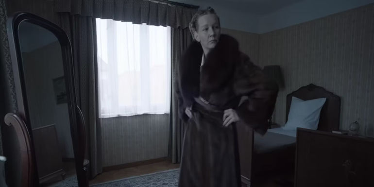 Sandra Hüller as Hedwig Höss standing in a bed room in The Zone of Interest trailer