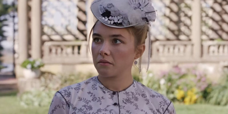 Amy March (Florence Pugh) frowning in a garden in Little Women