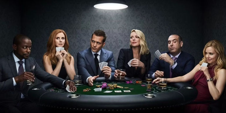 The cast of Suits is sitting at a poker table.