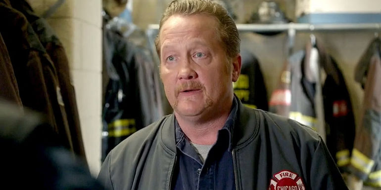 Mouch looking at someone with a serious expression in Chicago Fire