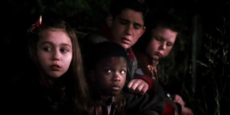Young Miley Cyrus as Ruthie with other kids in Big Fish's flashback scenes