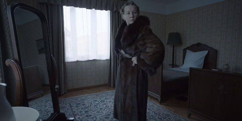 sandra-huller-as-hedwig-hoss-trying-on-a-fur-coat-in-the-zone-of-interest