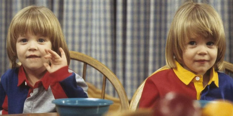 Nicky and Alex Katsopolis sit at a table in Full House