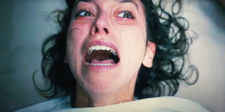 A woman screaming in distress in The First Omen