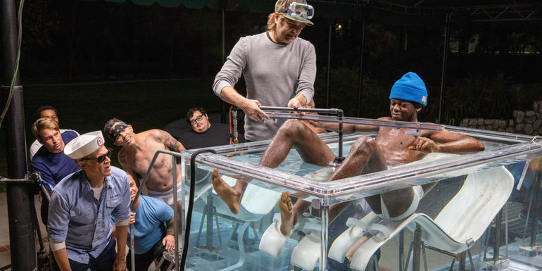 Jasper sits in a clear glass of water in Jackass Forever.