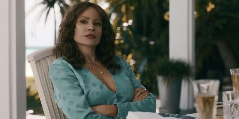 Sofia Vergara as Griselda sits with her arms crossed in a scene from Griselda.