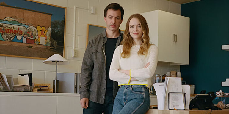 Nathan Fielder and Emma Stone as Whitney and Asher Siegel, standing in an office in The Curse
