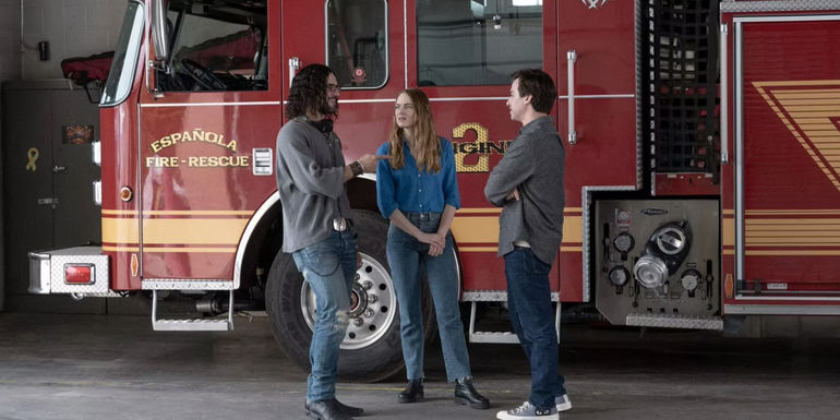 Dougie, Whitney, and Asher in front of a fire engine in The Curse