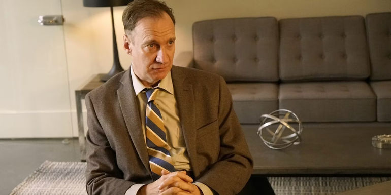 VM Varga sits on a couch in Fargo