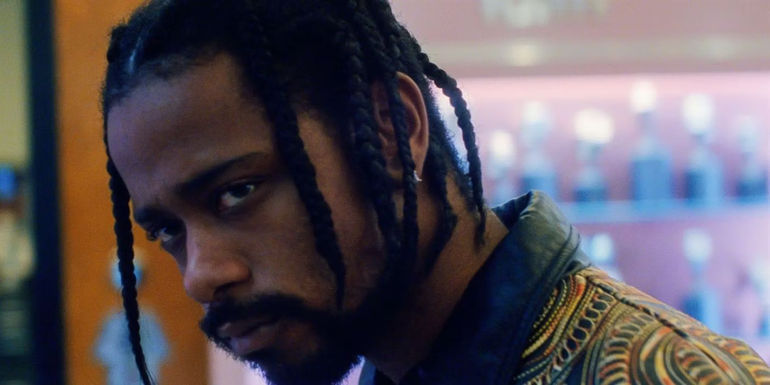LaKeith Stanfield as Demany stares at an off-screen character in Uncut Gems.