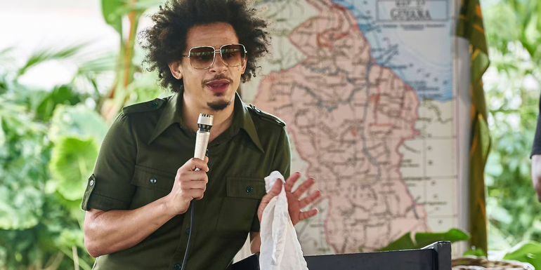 Eric Andre with a microphone in Man Seeking Woman Season 3