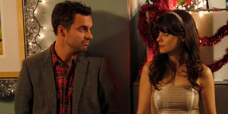 Nick and Jess looking at one another during a Christmas party in New Girl season 1