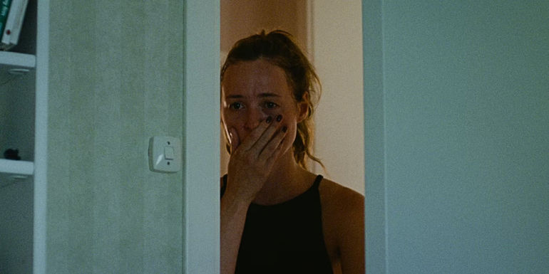 anna-looks-through-a-doorway-in-handling-the-undead