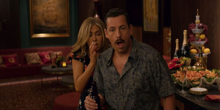 Adam Sandler and Jennifer Aniston looking shocked in Murder Mystery