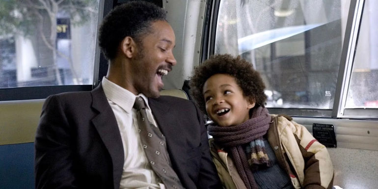 Chris and Christopher Jr. smiling at one another