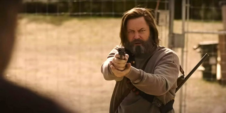 Nick Offerman as Bill pointing a gun at Frank in The Last of Us
