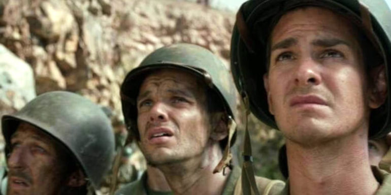 Private Doss (Andrew Garfield) and other soldiers looking up in the movie Hacksaw Ridge.
