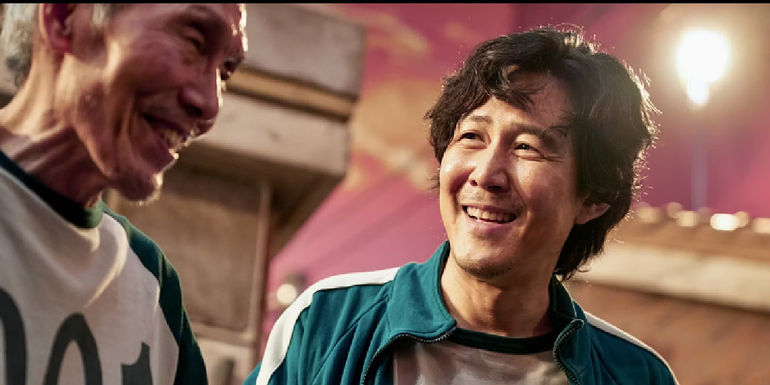 II-Nam and Gi-hun smile in Squid Games.