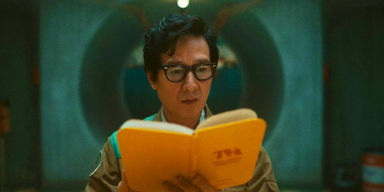Ke Huy Quan's Ouroboros with the new TVA guidebook at the end of Loki season 2