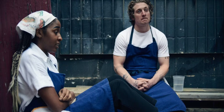 Sydney and Carmy sitting in The Bear