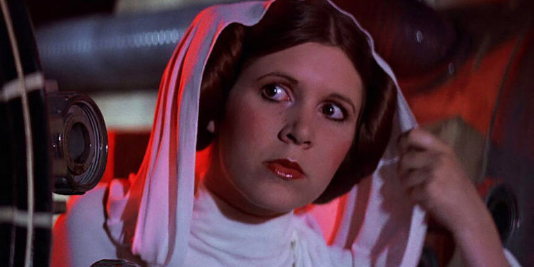 Carrie Fisher as Princess Leia pulling her hood back in A New Hope