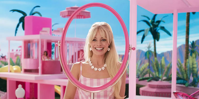 Barbie in her dreamhouse looking in the mirror in Barbie.