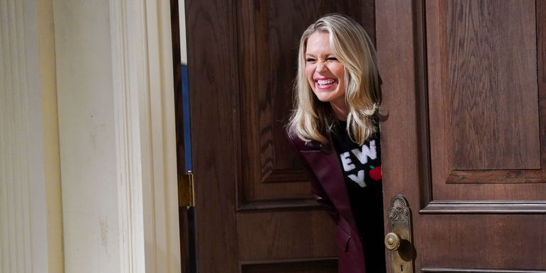 Jessica St. Clair as Heather smiling at someone in the courtroom in Night Court 206.