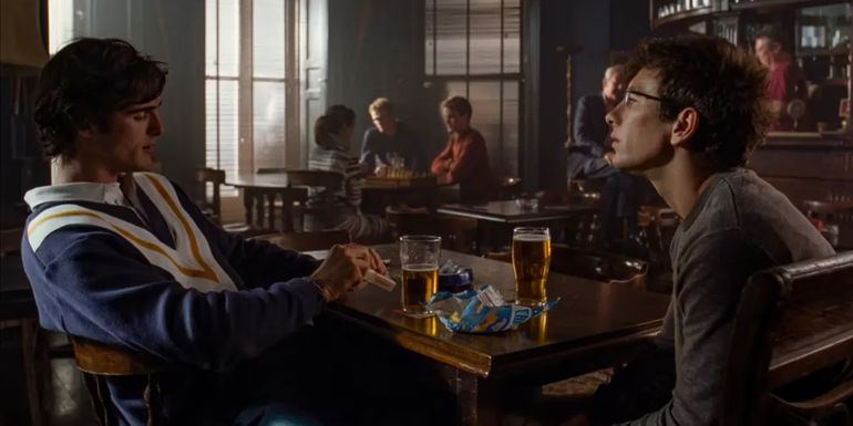 Oliver and Felix chatting over a pint in the student bar in Saltburn