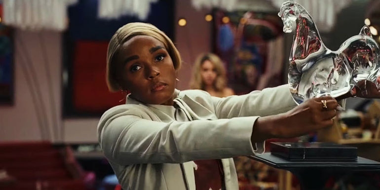 Janelle Monae as Helen, about to break a glass sculpture in Glass Onion: A Knives Out Mystery.