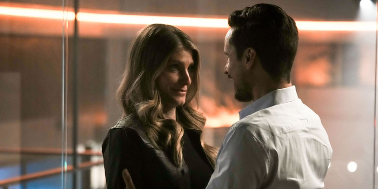 Caitlin Bassett as Addison and Peter Gadiot as Tom Westfall smiling at each other in Quantum Leap 209.