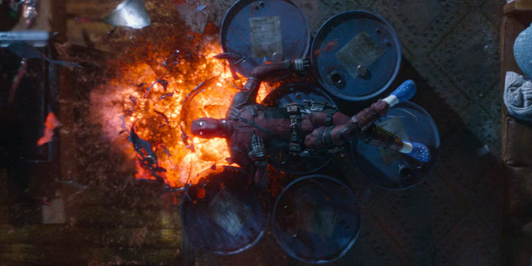 Deadpool lays on a pile of exploding barrels in Deadpool 2