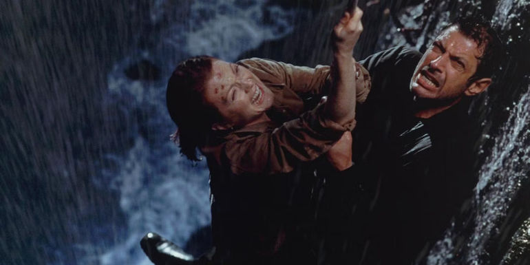 Sarah Harding and Ian Malcolm hanging onto the rope in Jurassic Park The Lost World