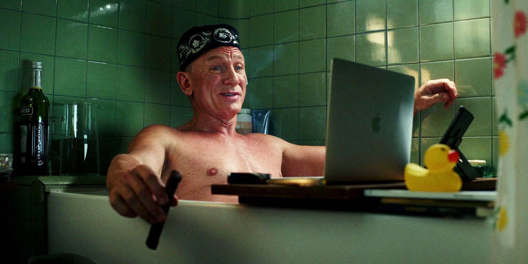Daniel Craig as Benoit Blanc sitting in the bathtub in Glass Onion: A Knives Out Mystery