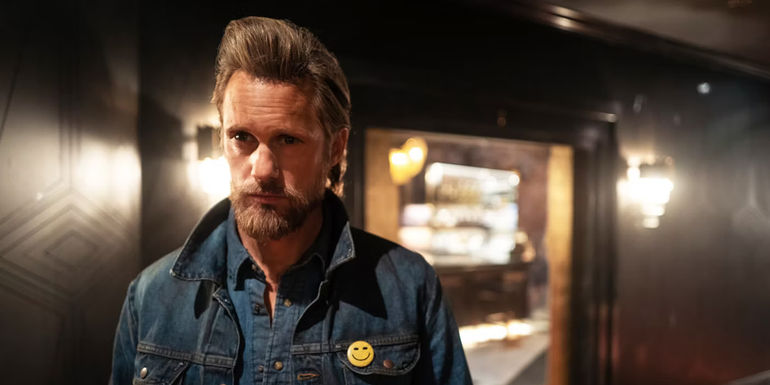 Alexander Skarsgard as Randall Flagg standing in the middle of a corridor in The Stand