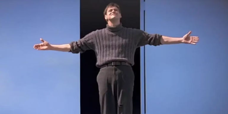 An image of Jim Carrey as Truman Burbank standing with his arms outstretched in the finale of The Truman Show