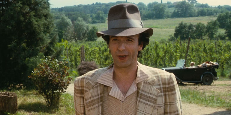 Guido (Roberto Benigni) wearing a suit in the Italian countryside in Life is Beautiful.