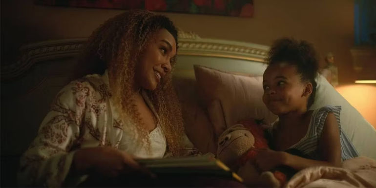 Emmy Raver-Lampman as Allison Hargreeves Reading to Coco Assad as Claire in Bed in The Umbrella Academy