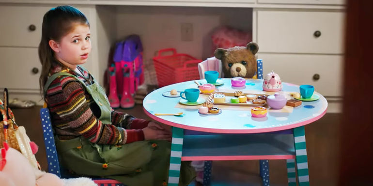 Pyper Braun as Alice sitting at a table with Chauncey in Imaginary Blumhouse