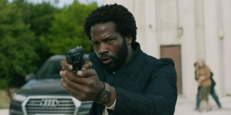 Sope Dirisu as Sean Donovan pointing a gun in Slow Horses