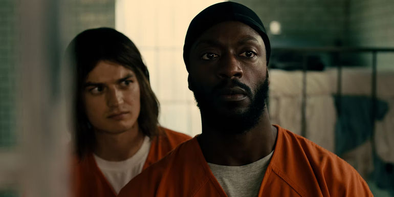 Joe Keery & Aldis Hodge in a prison cell in Marmalade
