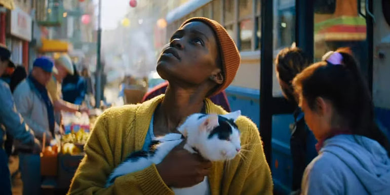 Lupita Nyong'o holding a cat on the streets of New York in A Quiet Place: Day One