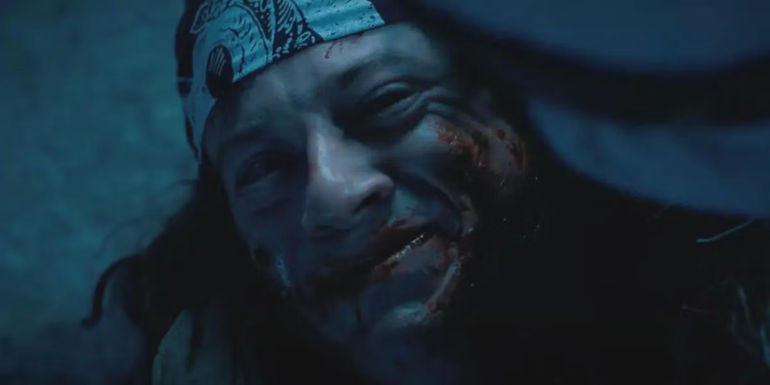Bloody Eddie Munson smiling tearfully at Dustin Henderson in Stranger Things.