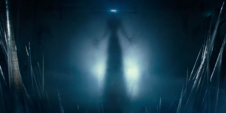 A shadowy ghost figure silhouette with glowing eyes stands menacingly in Ghostbusters: Frozen Empire.