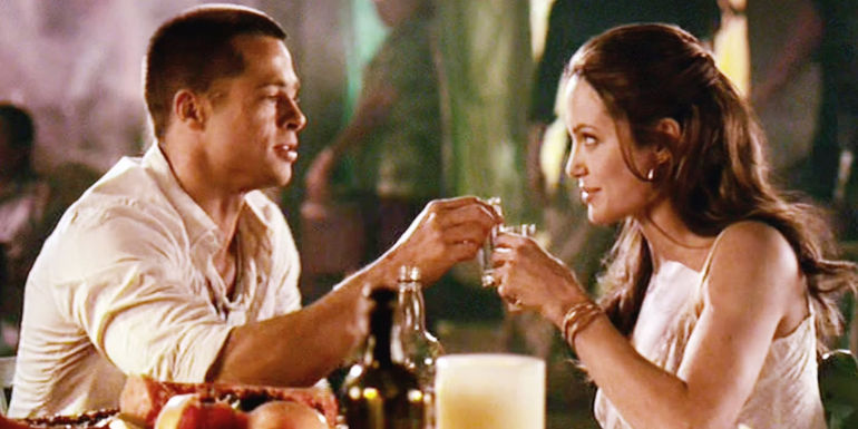 John and Jane clinking glasses at dinner table in Mr. & Mrs. Smith movie