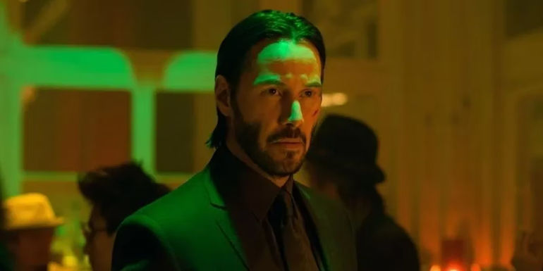 Keanu Reeves with Green Neon Light Shining on His Face in John Wick 