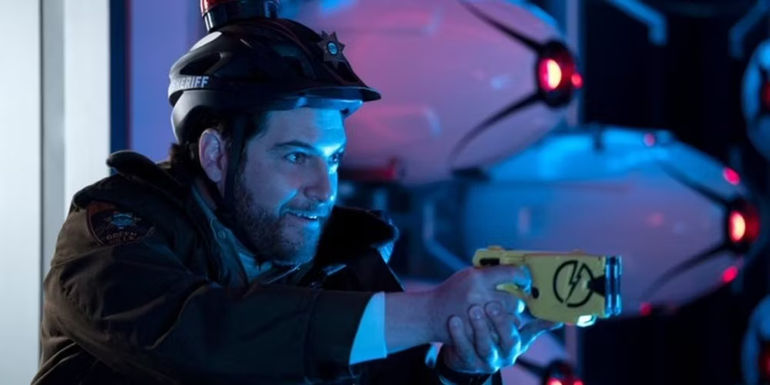 Wade Whipple pointing a taser gun in Sonic the Hedgehog 2 