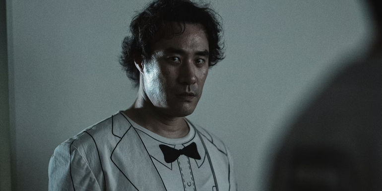 A character wearing a white suit in The 8 Show