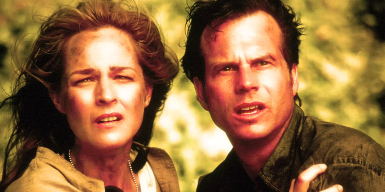 Helen Hunt's Jo and Bill Paxton's Bill looking off into the distance while holding each other In Twister