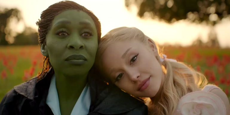 Galinda (Ariana Grande) leans her head on Elphaba (Cynthia Erivo)'s shoulder in the Wicked movie trailer.